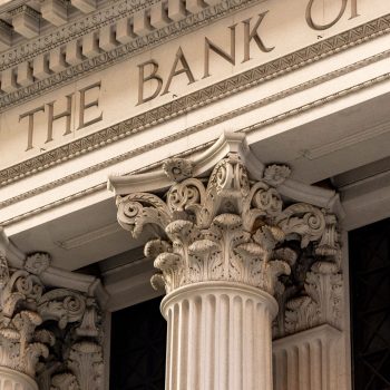 A detailed view of a classic bank building facade with ornate Corinthian columns.